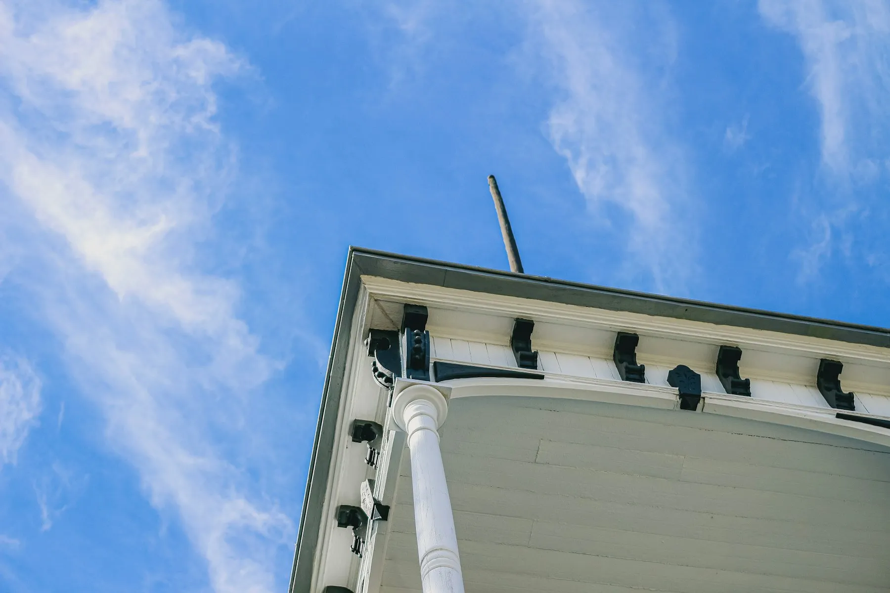 Gutter and eaves detail against a blue sky