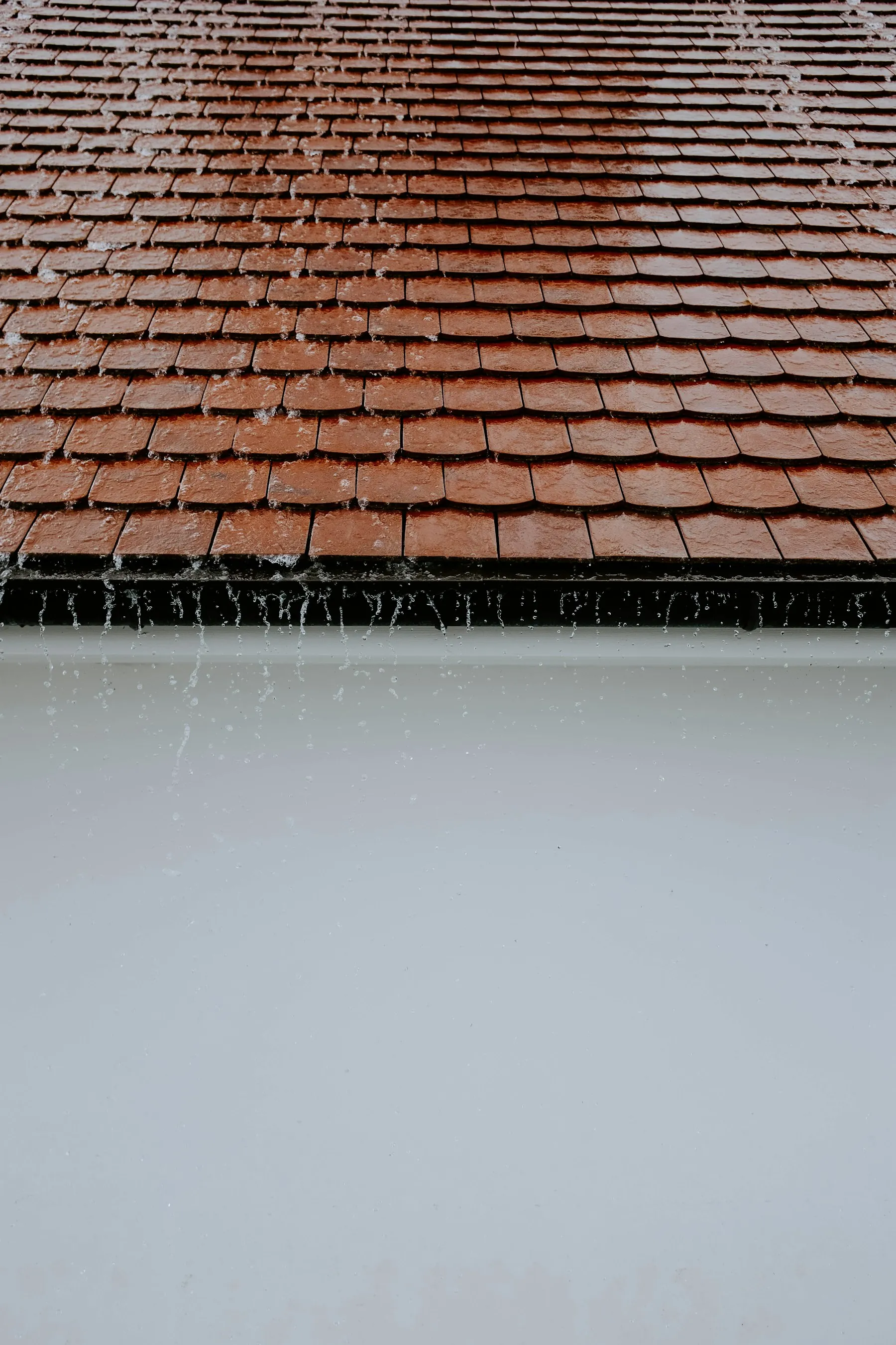 Rainwater running across a roof surface